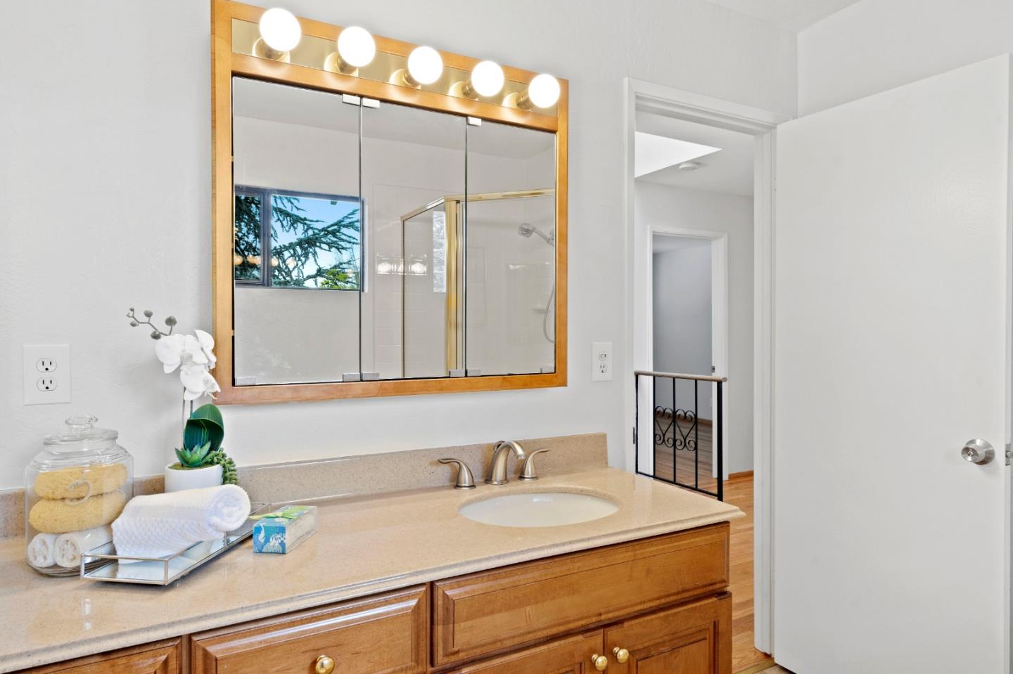 155 Belhaven Drive Los Gatos, CA 95032 - Photo 23 of 30 a bathroom with a granite countertop sink and a mirror