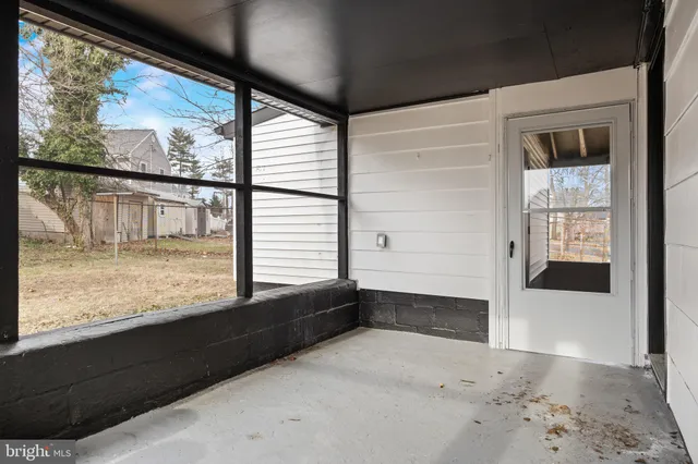 a backyard of a house with large trees and outdoor space