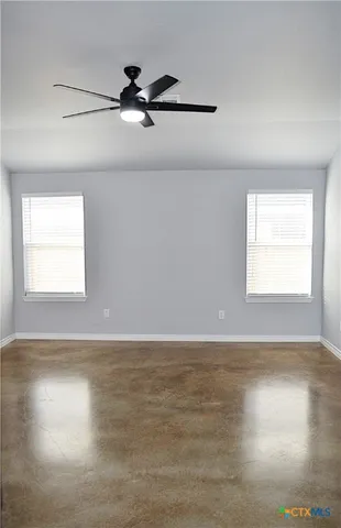 a view of a room with wooden floor and windows
