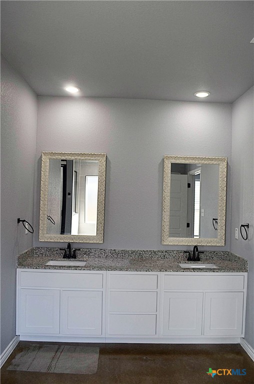 745 Freedom Circle Nolanville, TX 76559 - Photo 18 of 38 a bathroom with mirror sink and vanity