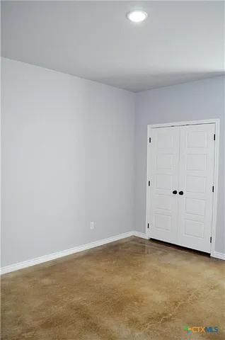 a white toilet and a bath tub sitting next to a white sink