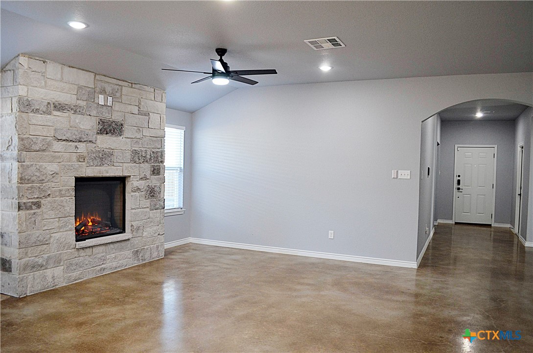 745 Freedom Circle Nolanville, TX 76559 - Photo 6 of 38 an empty room with fan and fireplace