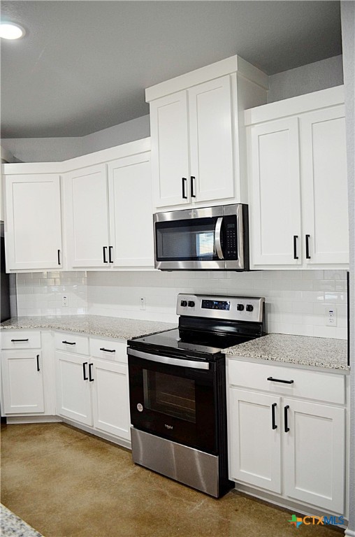 745 Freedom Circle Nolanville, TX 76559 - Photo 10 of 38 a kitchen with granite countertop a stove and a sink