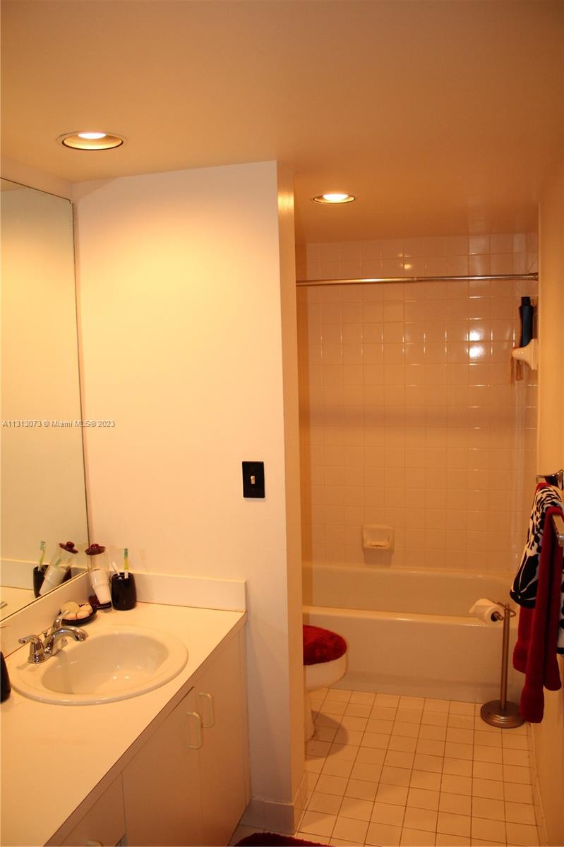 4730 Southwest 62nd Way, Unit 301 Davie, FL 33314 - Photo 12 of 33 a bathroom with a sink mirror and shower