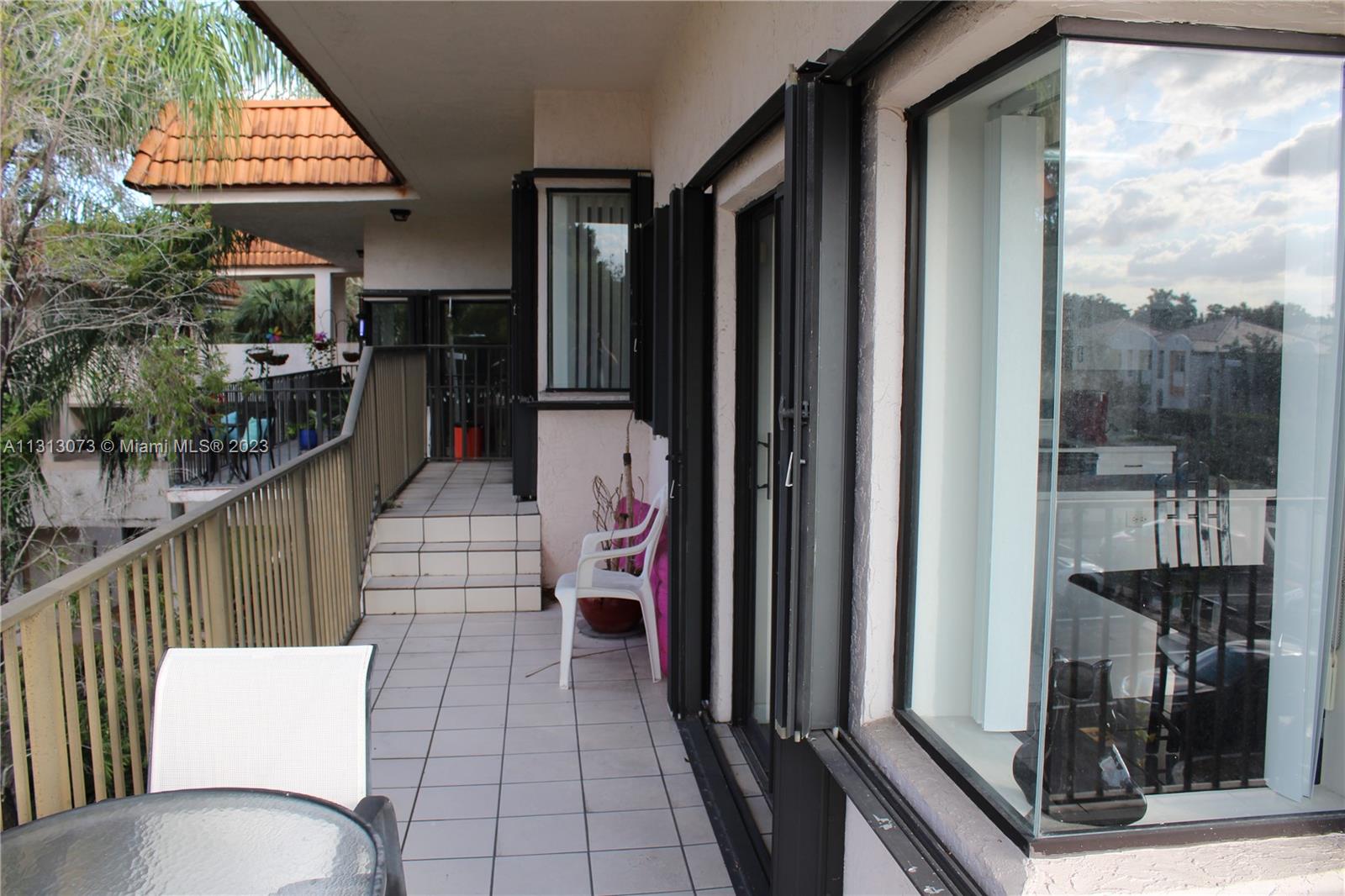 4730 Southwest 62nd Way, Unit 301 Davie, FL 33314 - Photo 14 of 33 a balcony view with a glass door