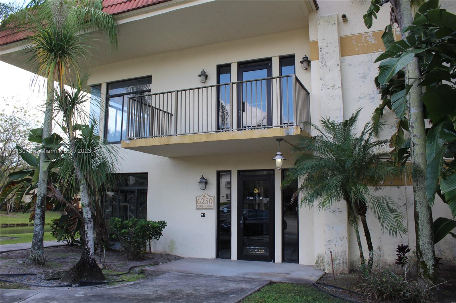 4730 Southwest 62nd Way, Unit 301 Davie, FL 33314 - Photo 15 of 33 a front view of a house with a yard