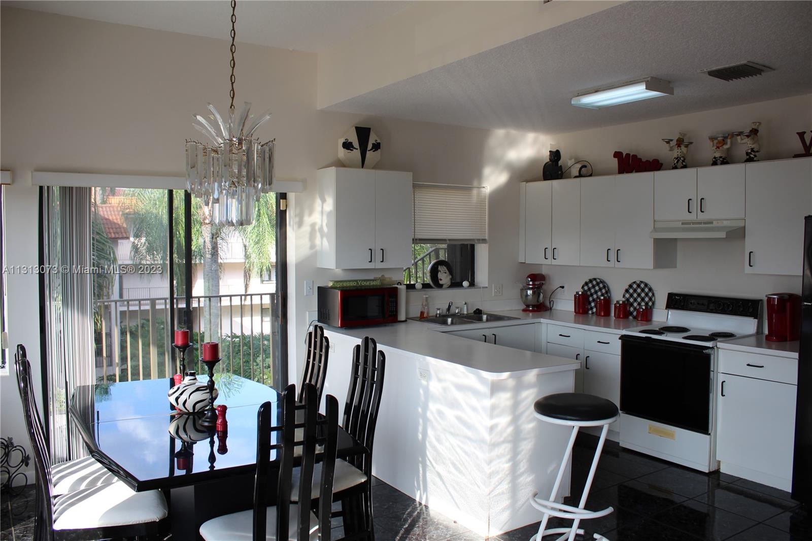 4730 Southwest 62nd Way, Unit 301 Davie, FL 33314 - Photo 6 of 33 a view of kitchen with dining table and chairs