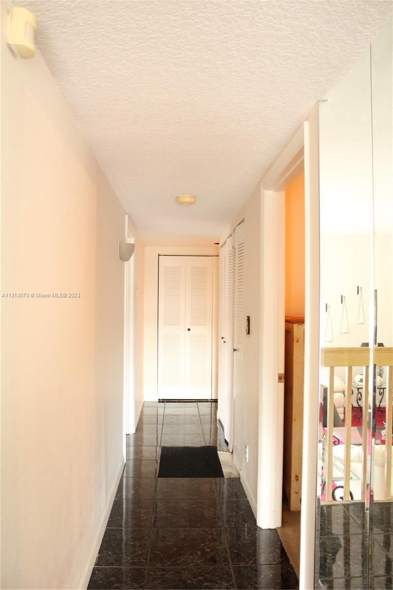 4730 Southwest 62nd Way, Unit 301 Davie, FL 33314 - Photo 10 of 33 a view of a hallway with wooden floor and entryway