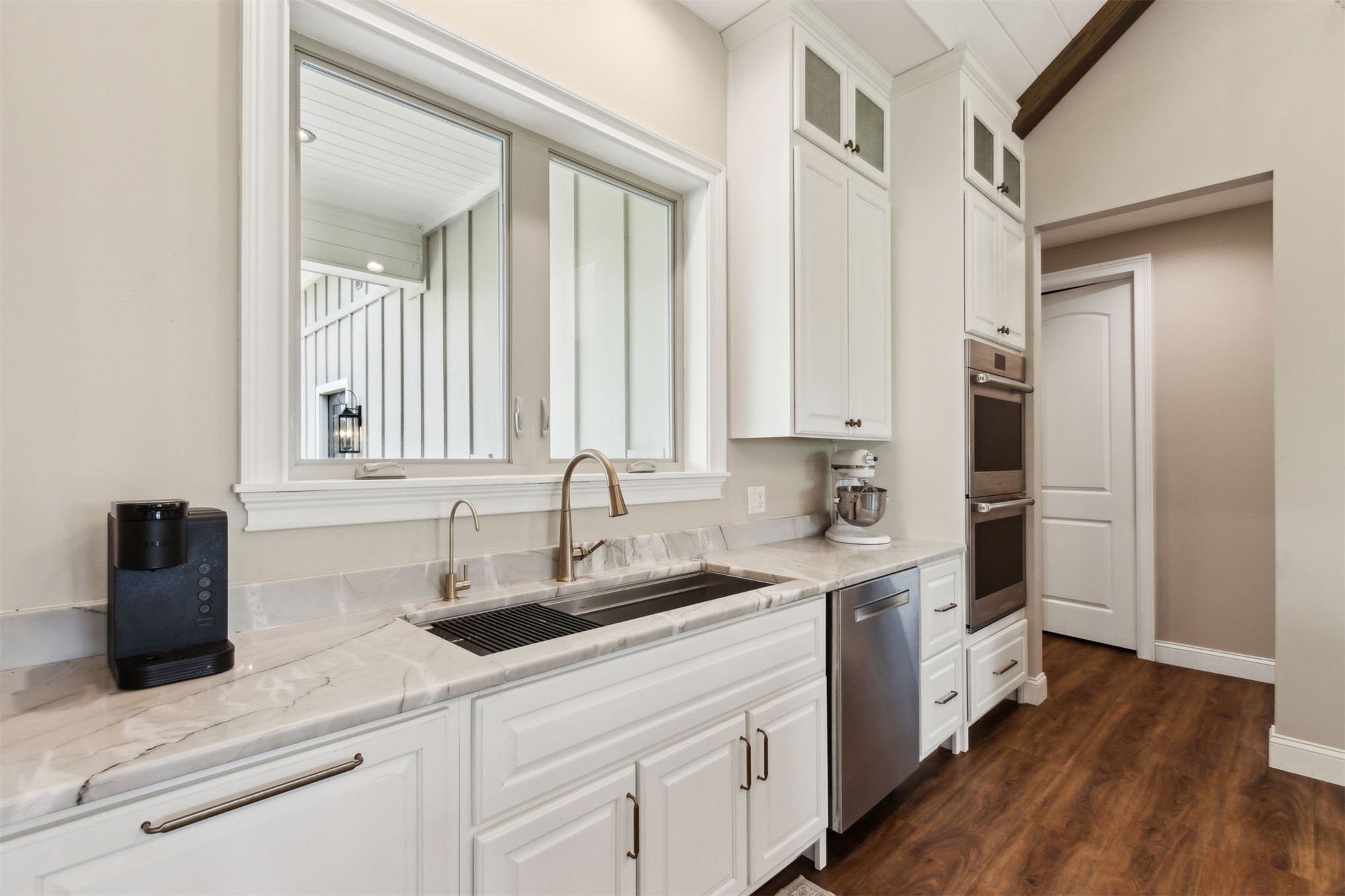 37854 Kings Ferry Road Hilliard, FL 32046 - Photo 23 of 52 a kitchen with a sink cabinets and wooden floor