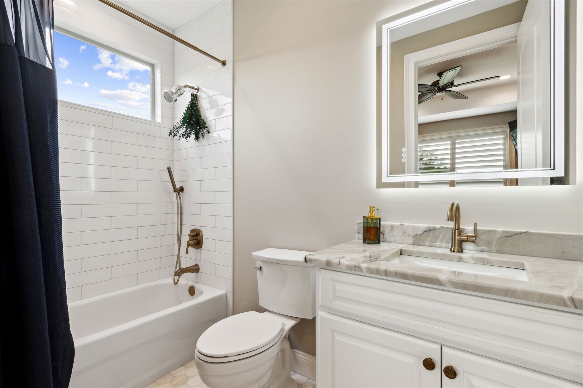 37854 Kings Ferry Road Hilliard, FL 32046 - Photo 36 of 52 a bathroom with a granite countertop toilet a sink and a bathtub