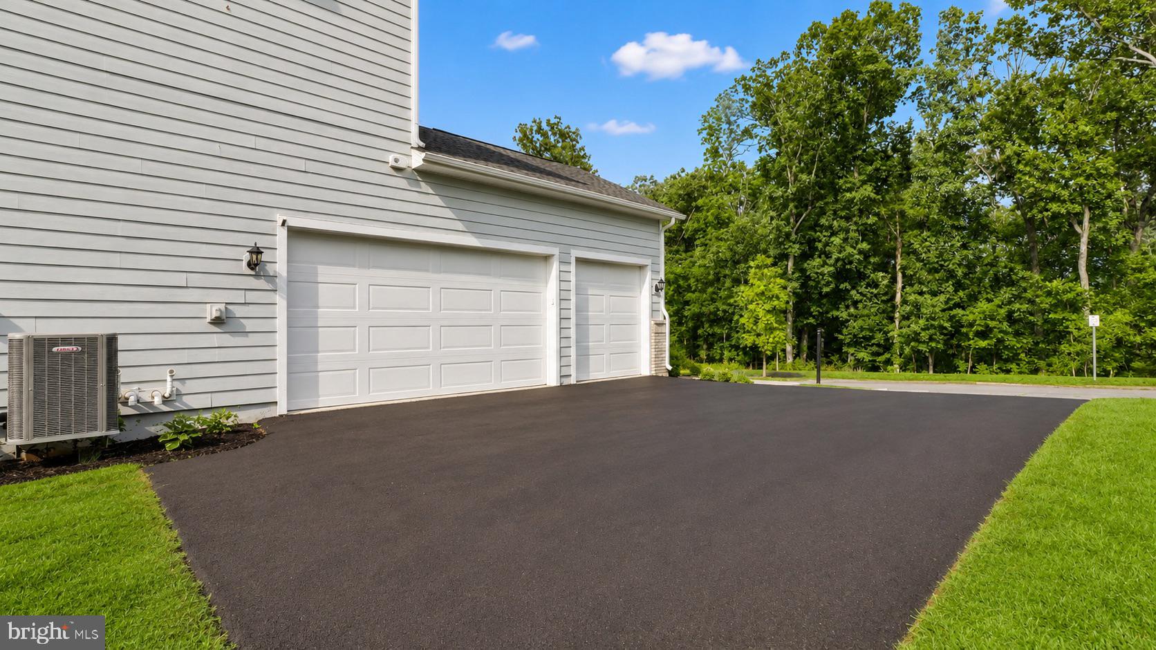 23609 Roselle Ridge Lane Aldie, VA 20105 - Photo 62 of 75 Spacious driveway with lush greenery.