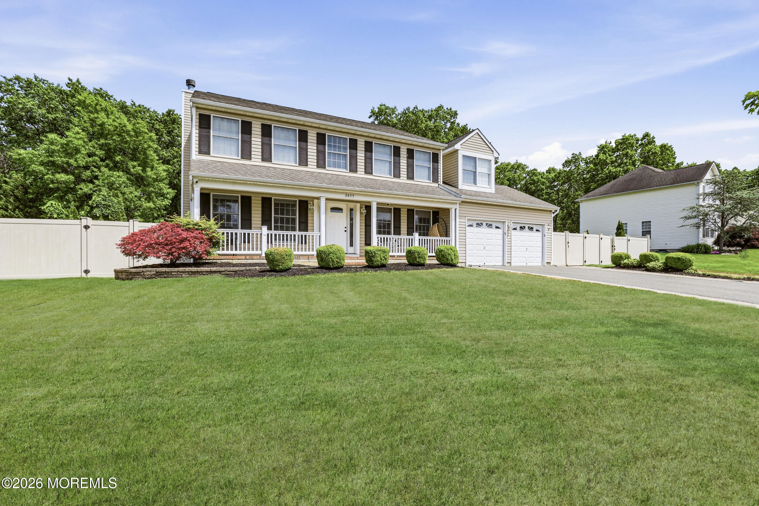 2055 MacKenzie Road Toms River, NJ 08755 - Photo 3 of 56 a front view of a house with a garden and trees