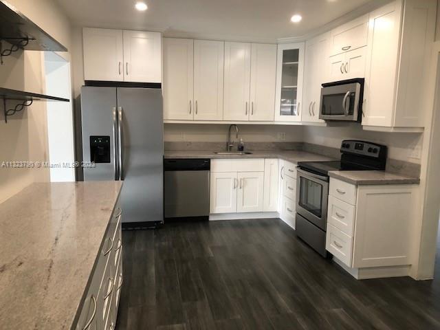 Flagami Miami, FL 33144 - Photo 2 of 4 a kitchen with a sink a microwave a refrigerator and cabinets