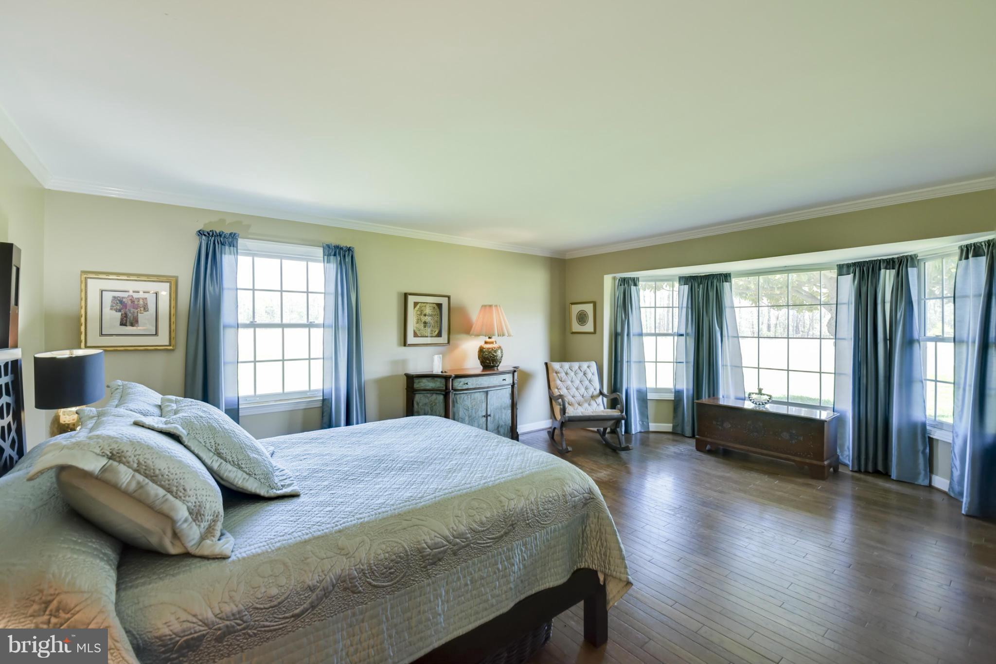 1901 Lowery Road Huntingtown, MD 20639 - Photo 17 of 30 a bedroom with a bed and a large window