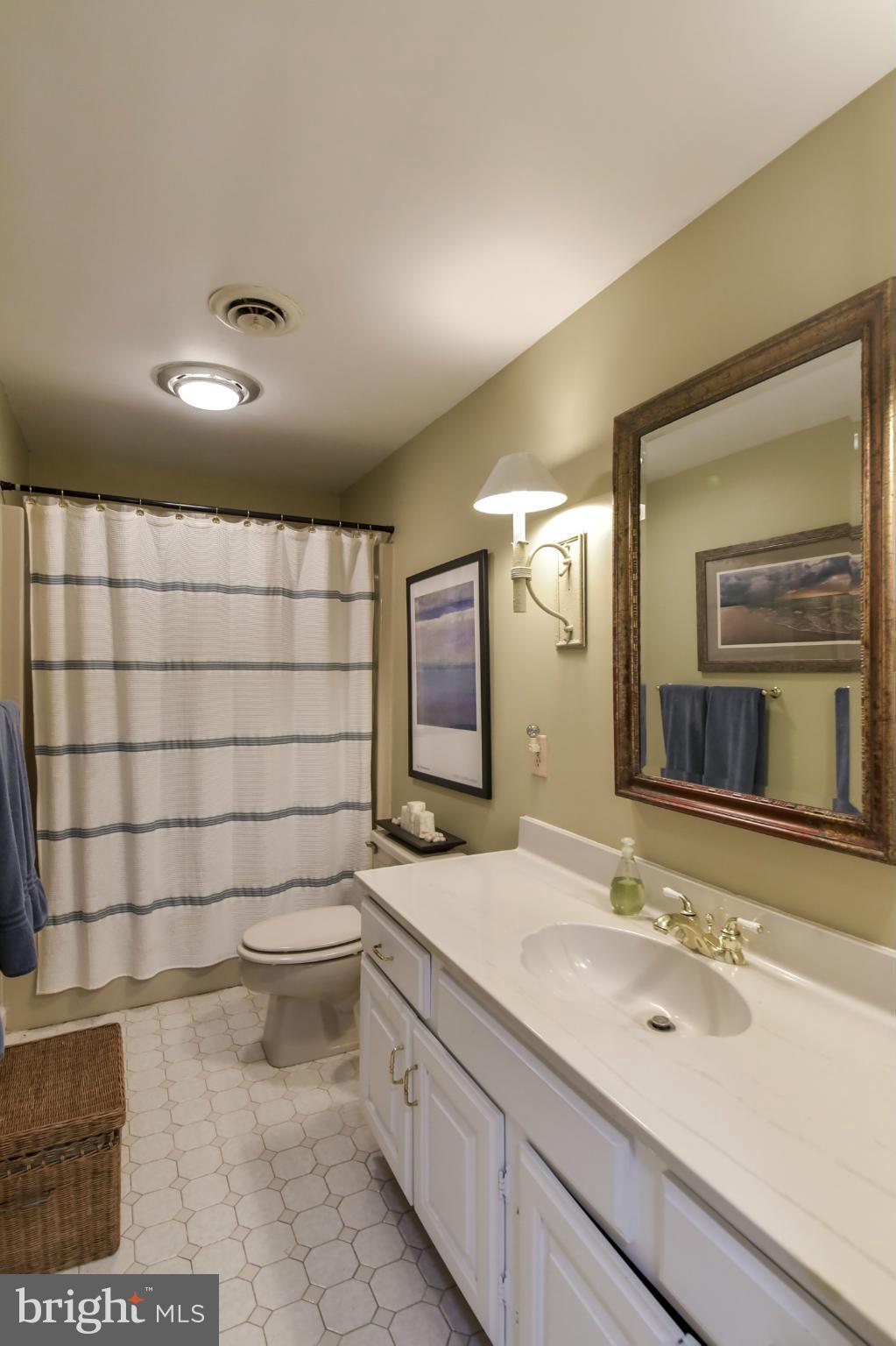 1901 Lowery Road Huntingtown, MD 20639 - Photo 23 of 30 a bathroom with a sink a toilet and mirror