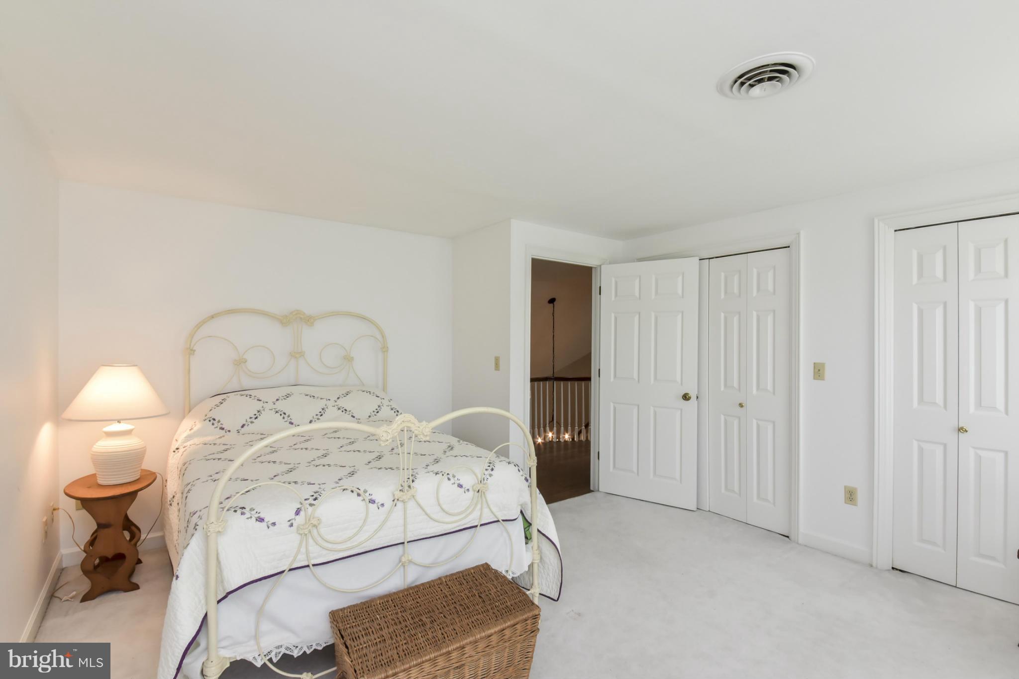 1901 Lowery Road Huntingtown, MD 20639 - Photo 24 of 30 a room with a bed and a chandelier