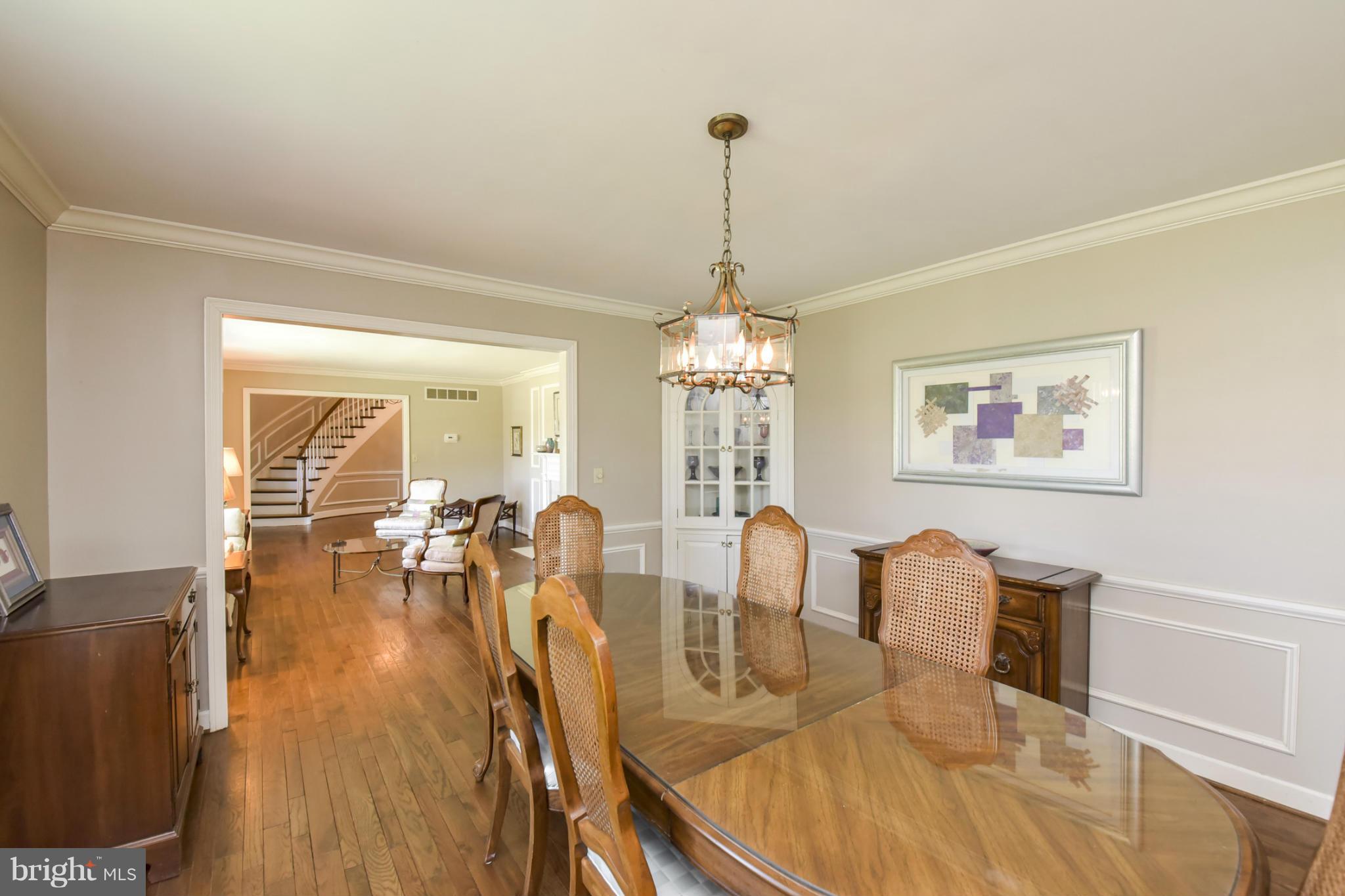 1901 Lowery Road Huntingtown, MD 20639 - Photo 6 of 30 a view of a dining room and livingroom with furniture wooden floor a chandelier