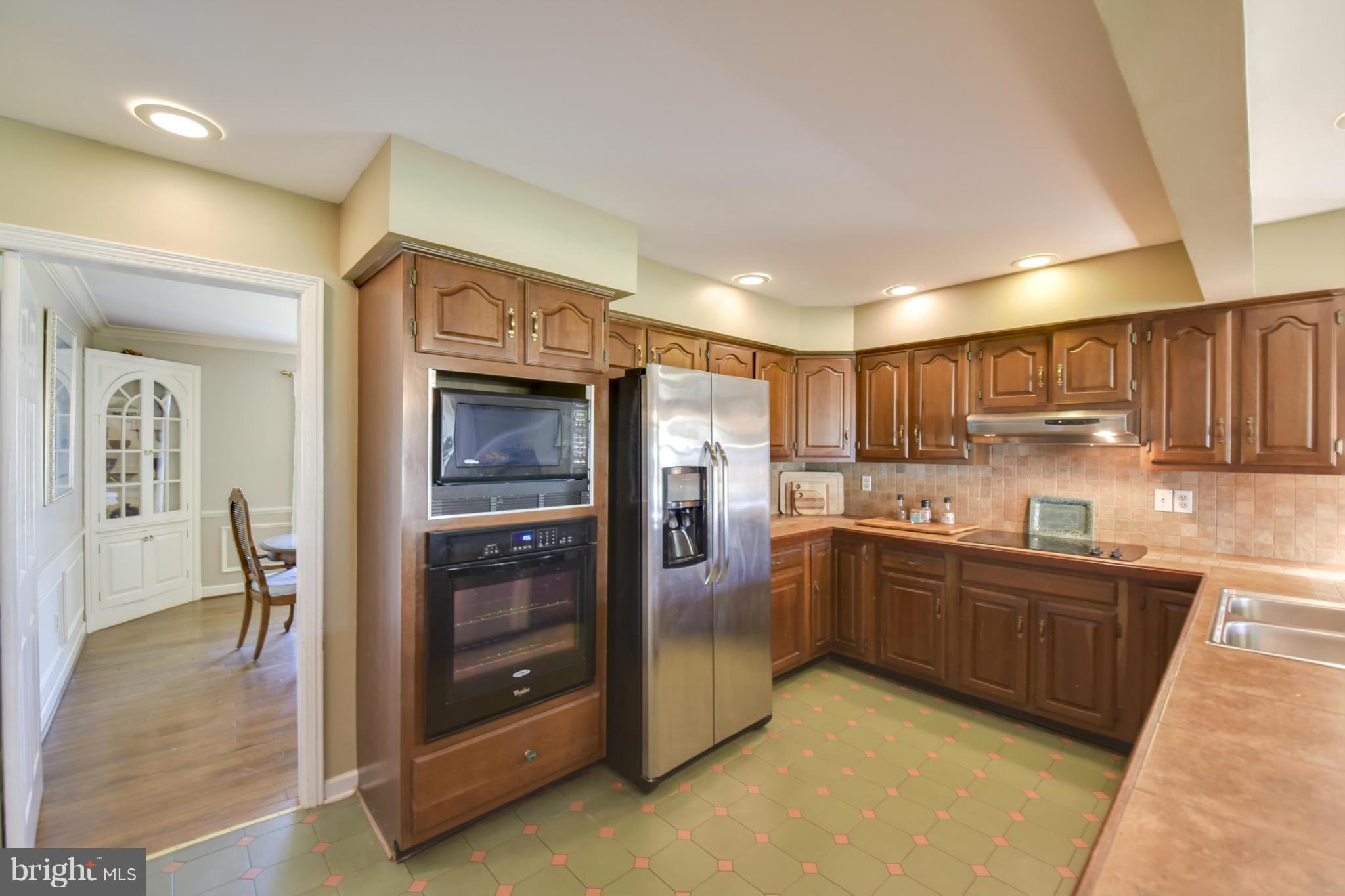 1901 Lowery Road Huntingtown, MD 20639 - Photo 7 of 30 a kitchen with stainless steel appliances granite countertop a refrigerator and a sink