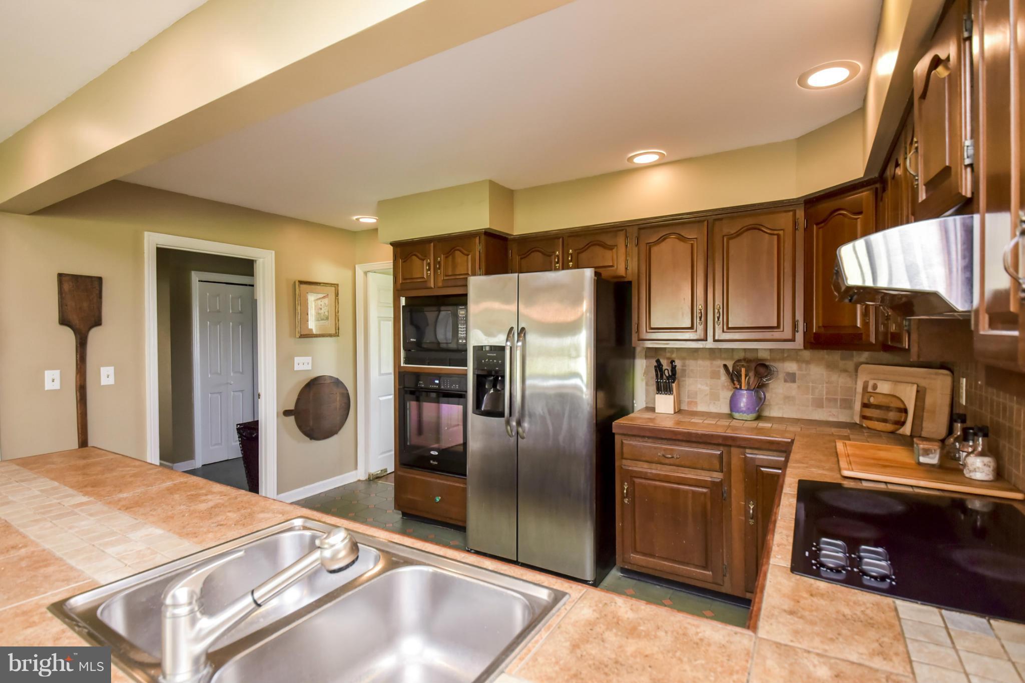 1901 Lowery Road Huntingtown, MD 20639 - Photo 8 of 30 a kitchen with stainless steel appliances granite countertop a sink refrigerator and cabinets