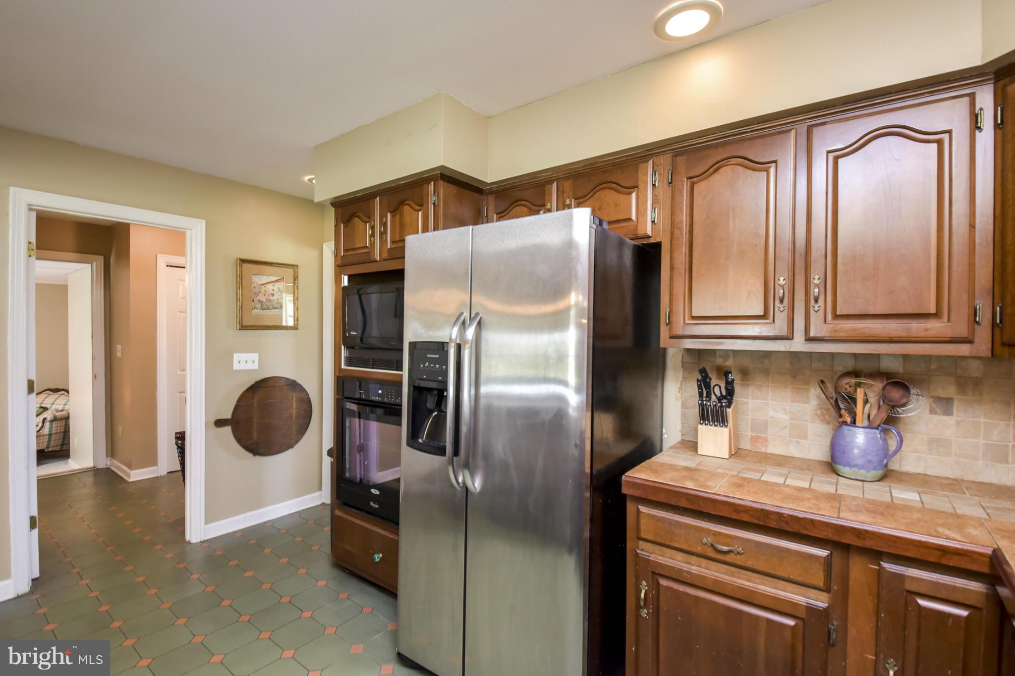 1901 Lowery Road Huntingtown, MD 20639 - Photo 9 of 30 a kitchen with granite countertop stainless steel appliances a refrigerator and cabinets