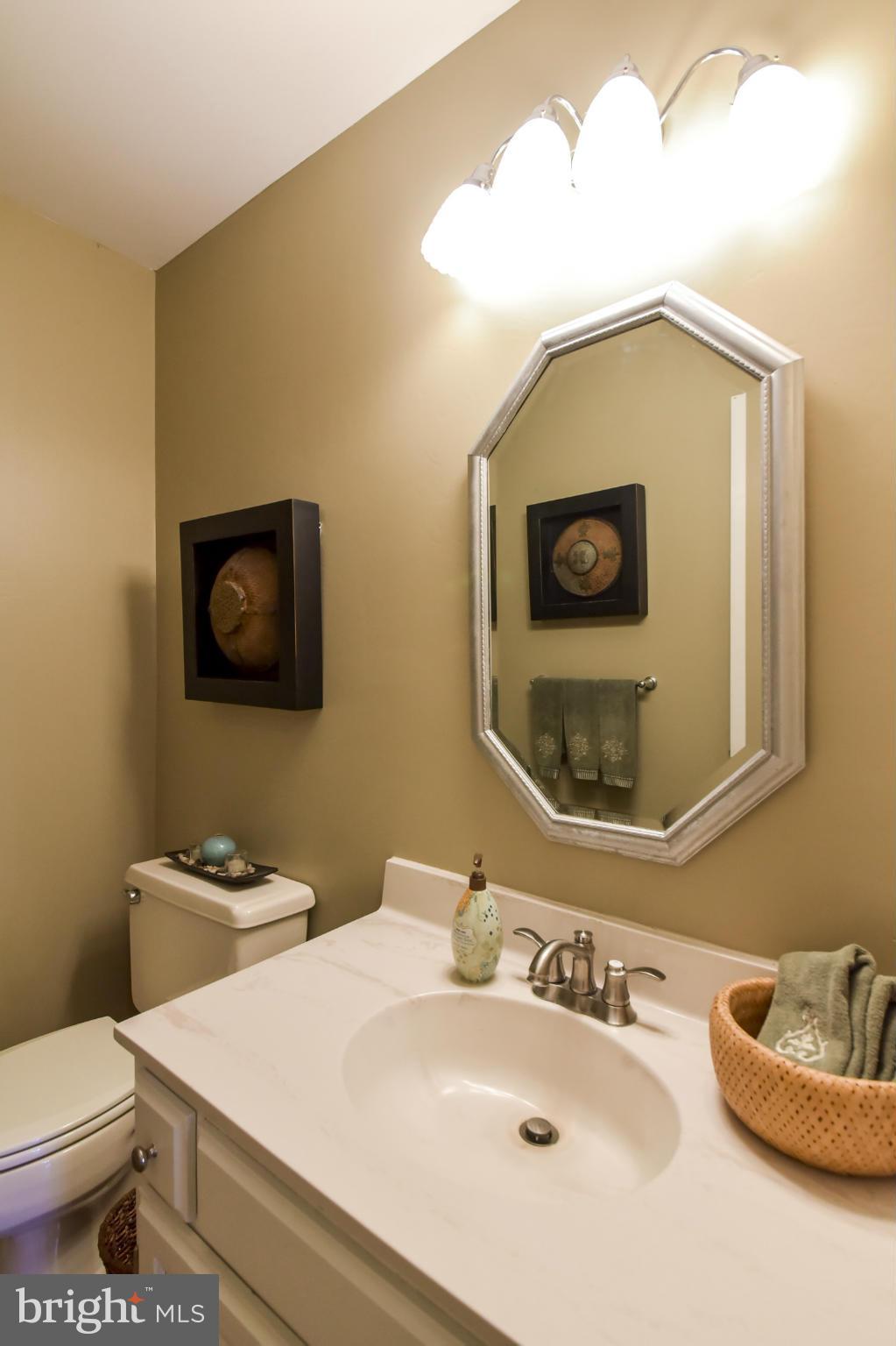 1901 Lowery Road Huntingtown, MD 20639 - Photo 10 of 30 a bathroom with a sink a mirror and toilet