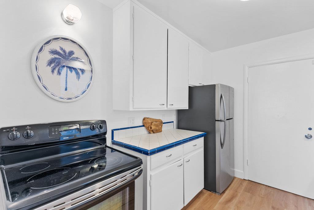403 Beach Drive Aptos, CA 95003 - Photo 11 of 24 a kitchen with a refrigerator and a stove top oven