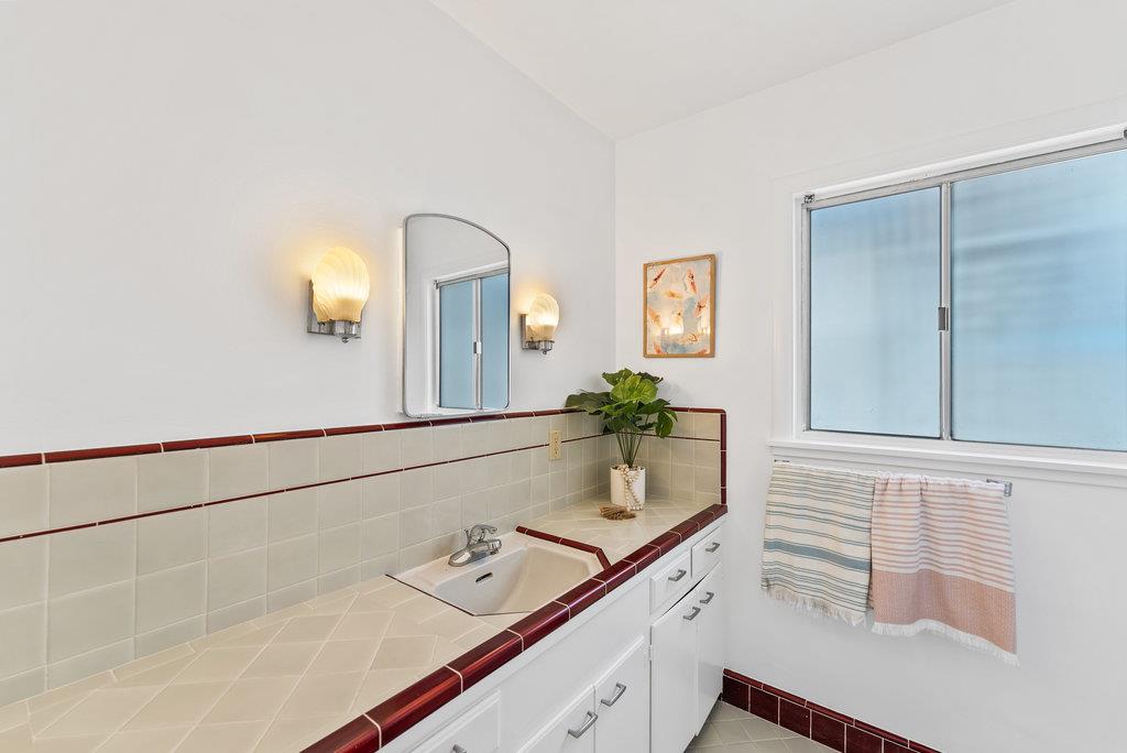 403 Beach Drive Aptos, CA 95003 - Photo 14 of 24 a bathroom with a sink and a mirror