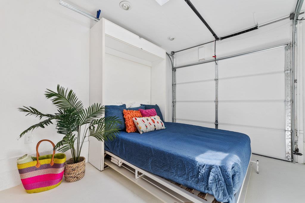 403 Beach Drive Aptos, CA 95003 - Photo 19 of 24 a bedroom with a bed and a potted plant on the dresser