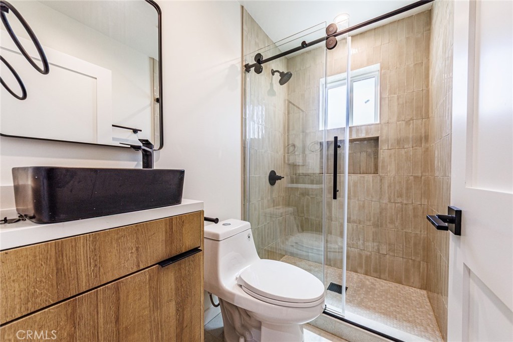1857 Crenshaw Boulevard, Unit 1/2 Los Angeles, CA 90019 - Photo 13 of 24 a bathroom with a shower and a toilet