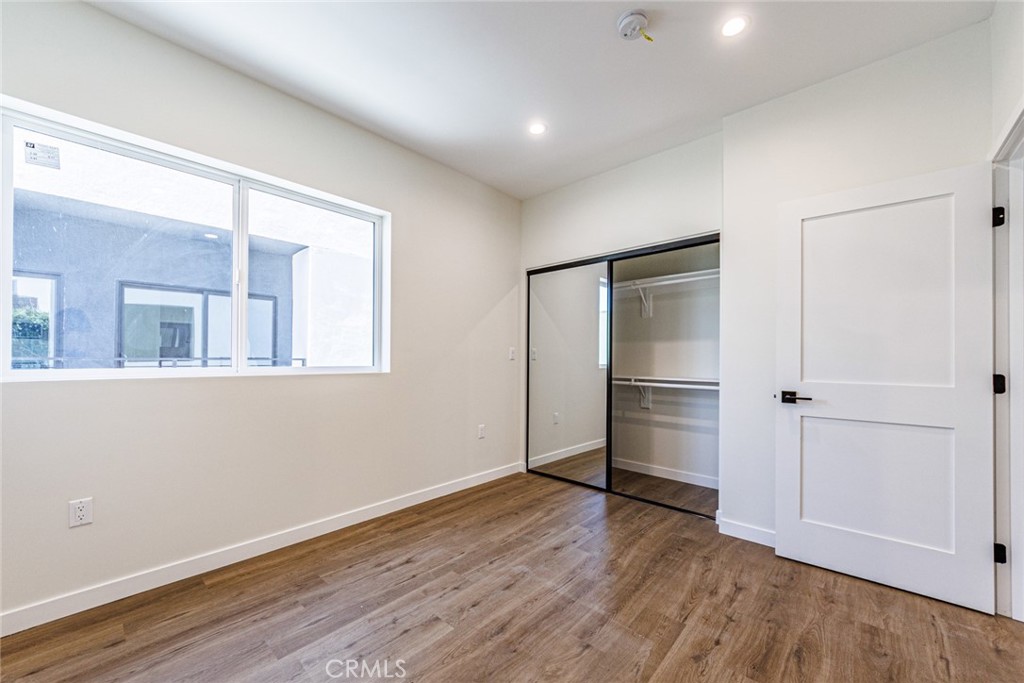 1857 Crenshaw Boulevard, Unit 1/2 Los Angeles, CA 90019 - Photo 15 of 24 a view of an empty room with wooden floor and closet