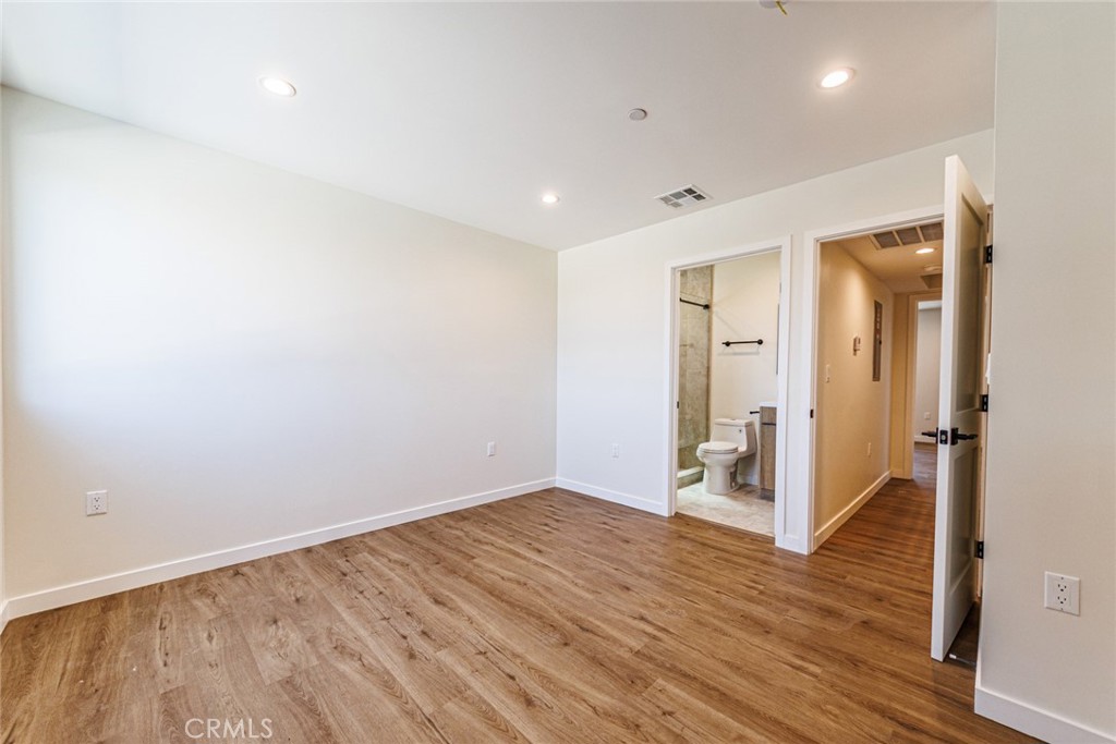 1857 Crenshaw Boulevard, Unit 1/2 Los Angeles, CA 90019 - Photo 19 of 24 wooden floor in an empty room