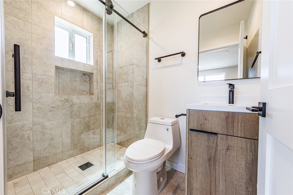 1857 Crenshaw Boulevard, Unit 1/2 Los Angeles, CA 90019 - Photo 21 of 24 a bathroom with a toilet sink and shower