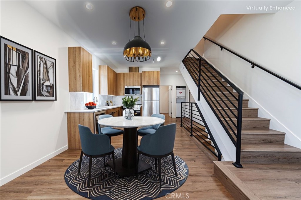 1857 Crenshaw Boulevard, Unit 1/2 Los Angeles, CA 90019 - Photo 3 of 24 a view of a dining room and livingroom with furniture wooden floor and a rug