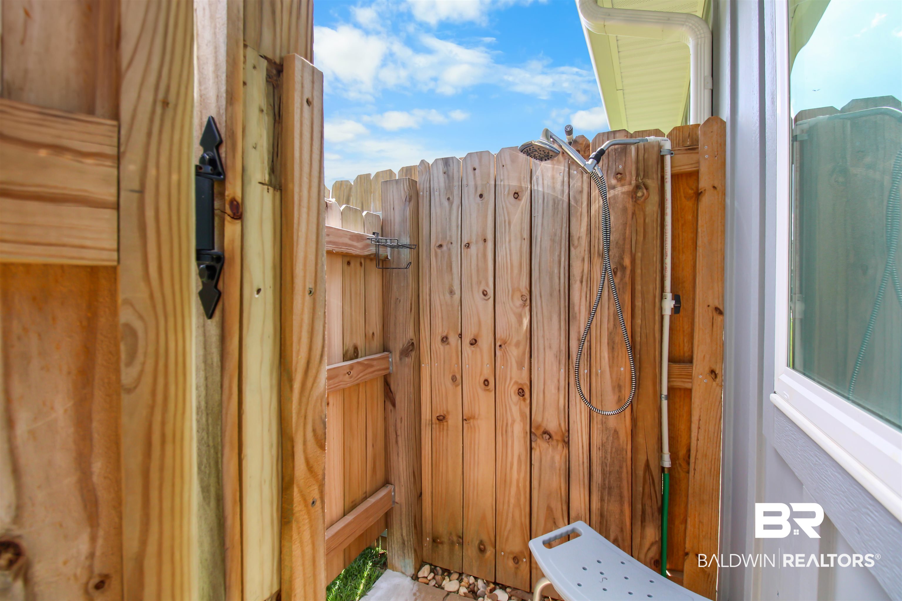 1885 Carly Street Foley, AL 36535 - Photo 31 of 40 Outdoor shower enclosure featuring natural wood fencing and a chrome shower head