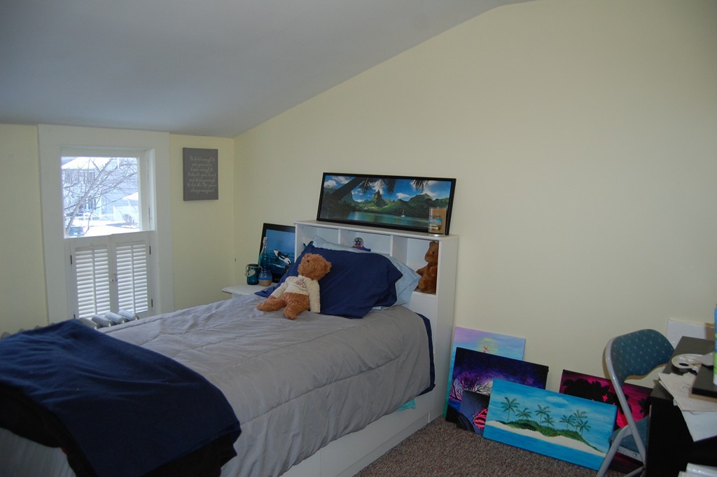 105 Gresham Street Springfield, MA 01119 - Photo 24 of 30 a bedroom with a bed a dresser and window