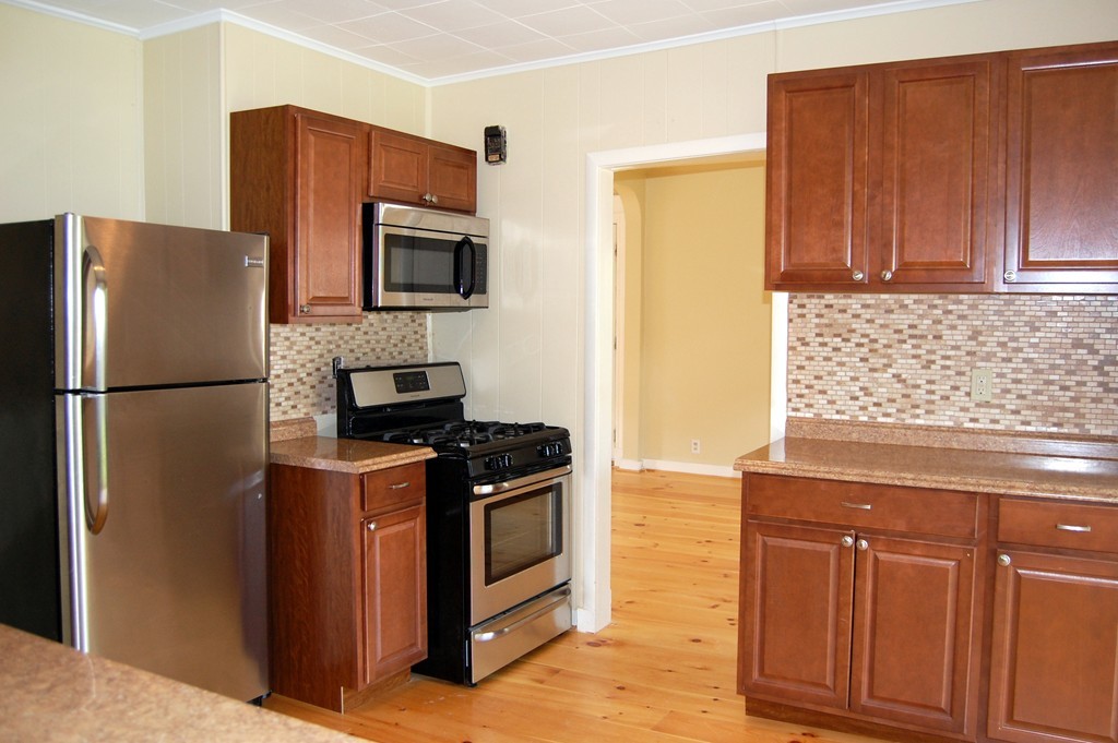 105 Gresham Street Springfield, MA 01119 - Photo 6 of 30 a kitchen with stainless steel appliances granite countertop a refrigerator stove and microwave