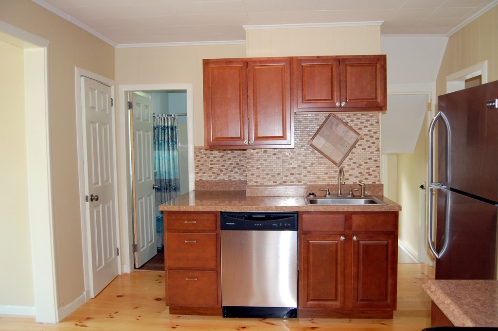 105 Gresham Street Springfield, MA 01119 - Photo 8 of 30 a kitchen with stainless steel appliances granite countertop a refrigerator and a stove