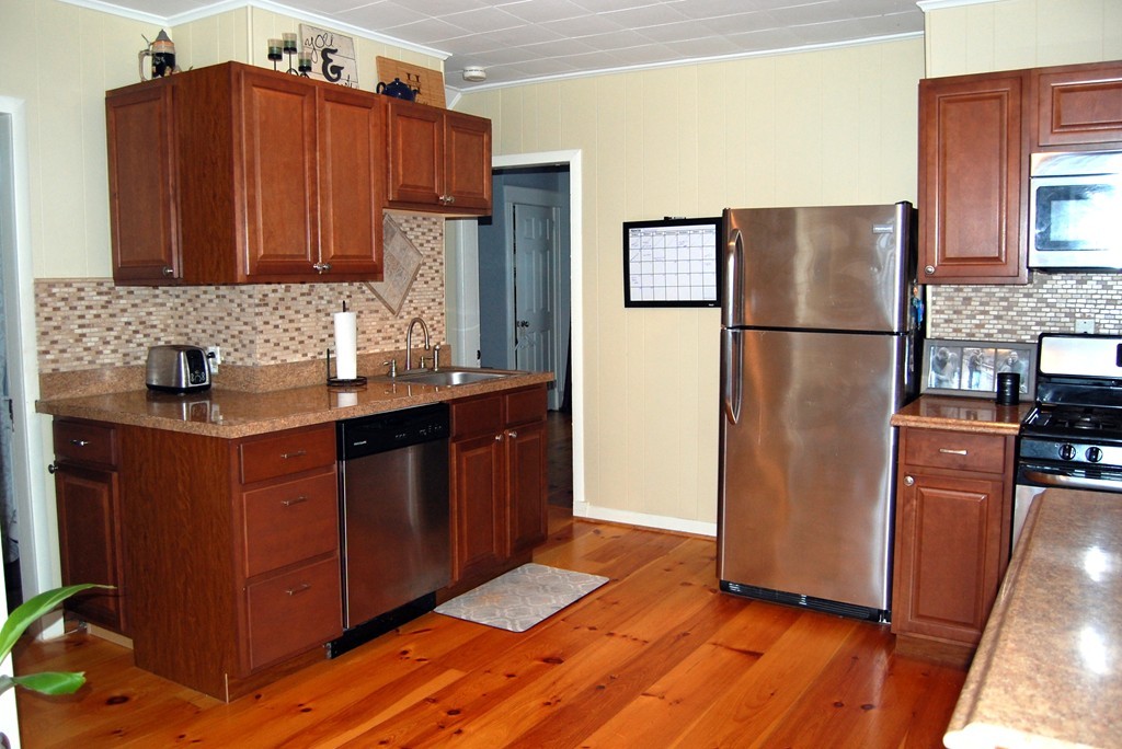 105 Gresham Street Springfield, MA 01119 - Photo 10 of 30 a kitchen with stainless steel appliances granite countertop a refrigerator and a sink
