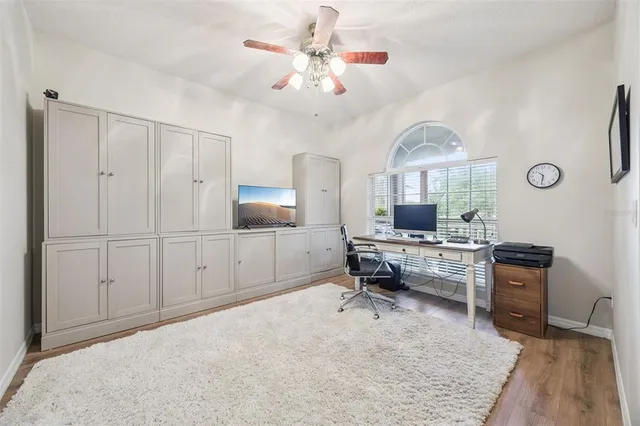 a kitchen with stainless steel appliances granite countertop a stove top oven a sink dishwasher and a refrigerator with wooden floor