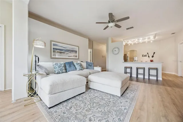 a living room with a bed and a chandelier
