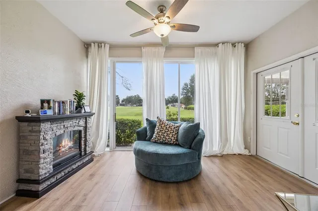 a bedroom with a bed a table and wooden floor