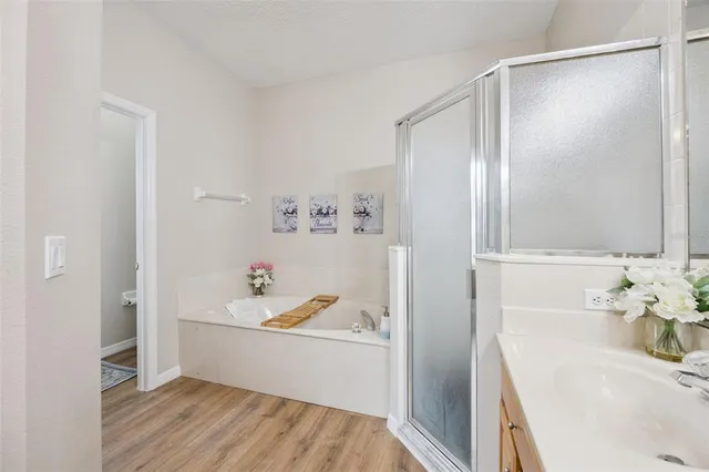 an aerial view of residential houses with outdoor space and trees