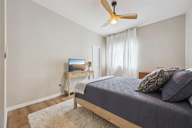 a view of a swimming pool with lawn chairs and plants