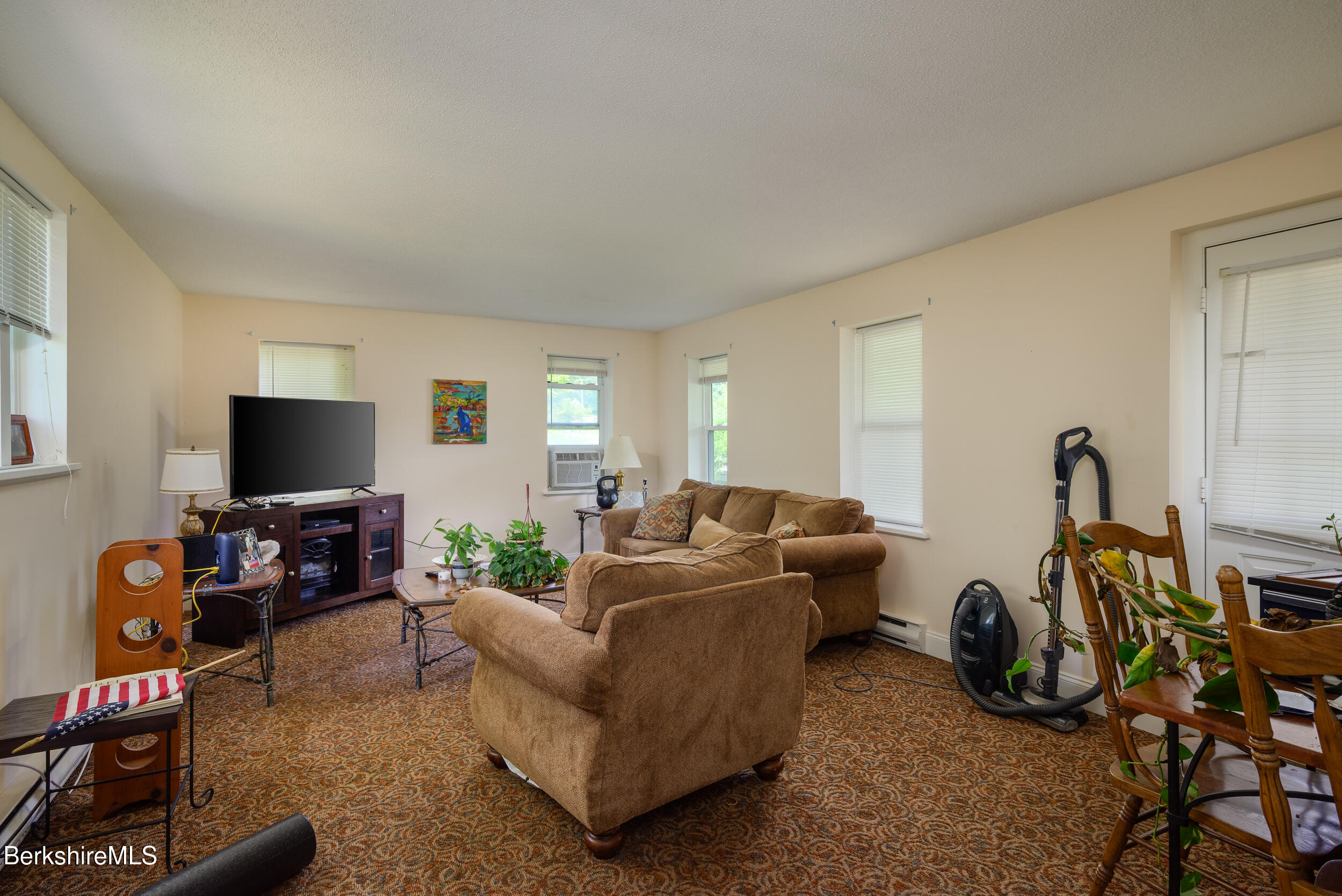 25-29 New Ashford Road Williamstown, MA 01267 - Photo 4 of 13 a living room with furniture a flat screen tv and a window