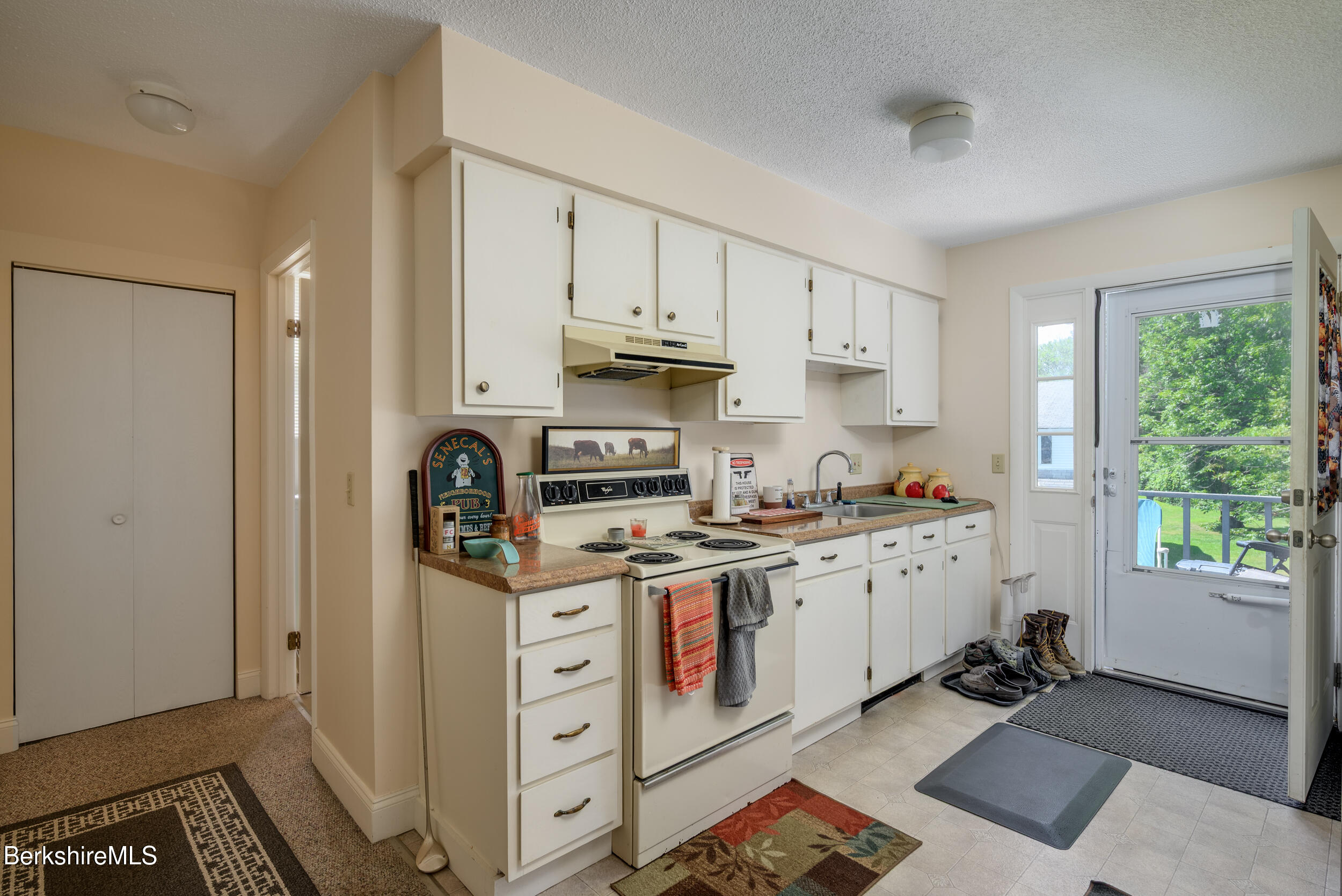 25-29 New Ashford Road Williamstown, MA 01267 - Photo 5 of 13 a kitchen with stainless steel appliances granite countertop a stove a sink and a refrigerator