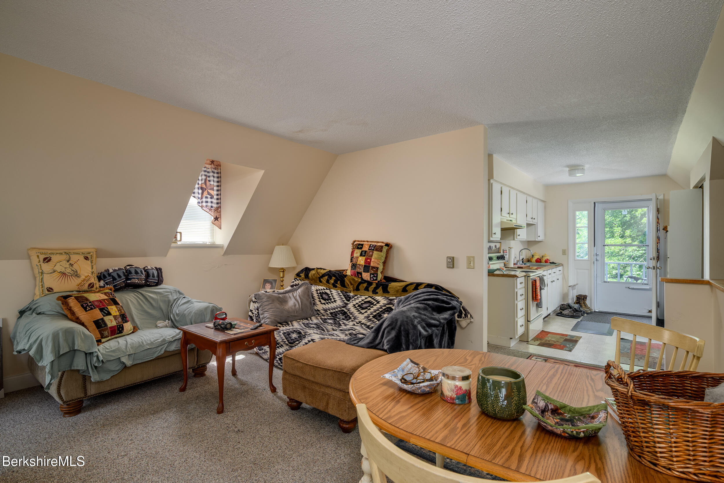 25-29 New Ashford Road Williamstown, MA 01267 - Photo 6 of 13 a living room with furniture and a table
