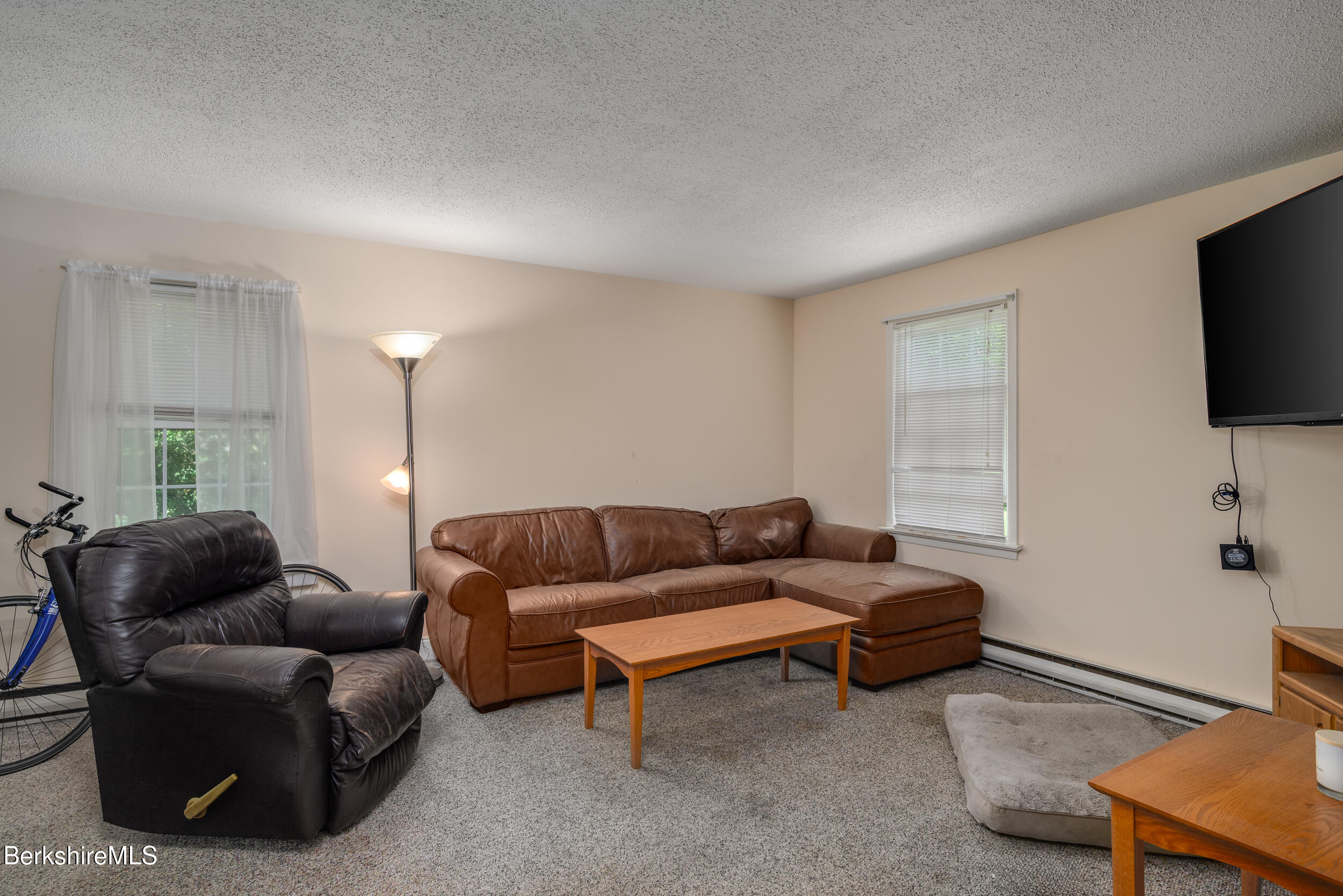25-29 New Ashford Road Williamstown, MA 01267 - Photo 10 of 13 a living room with furniture and a flat screen tv