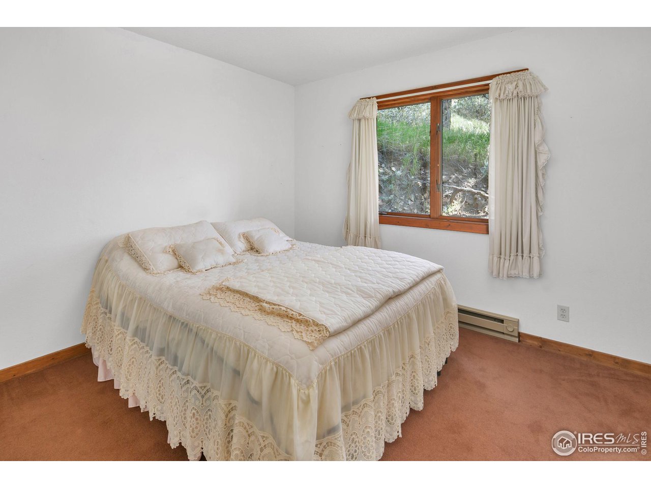 1052 Streamside Drive Drake, CO 80515 - Photo 13 of 31 a bedroom with a bed and a window