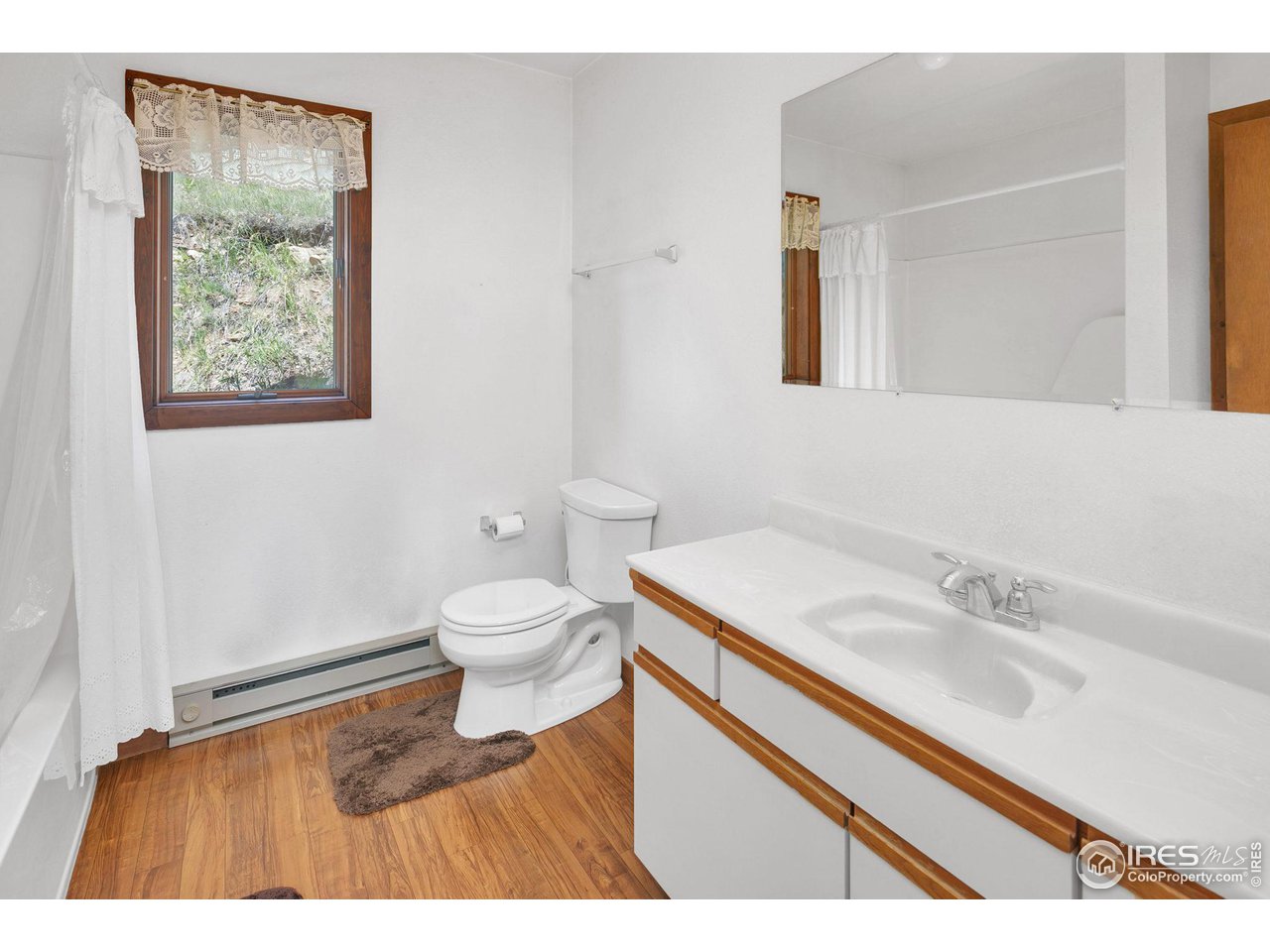 1052 Streamside Drive Drake, CO 80515 - Photo 15 of 31 a bathroom with a sink toilet and a mirror