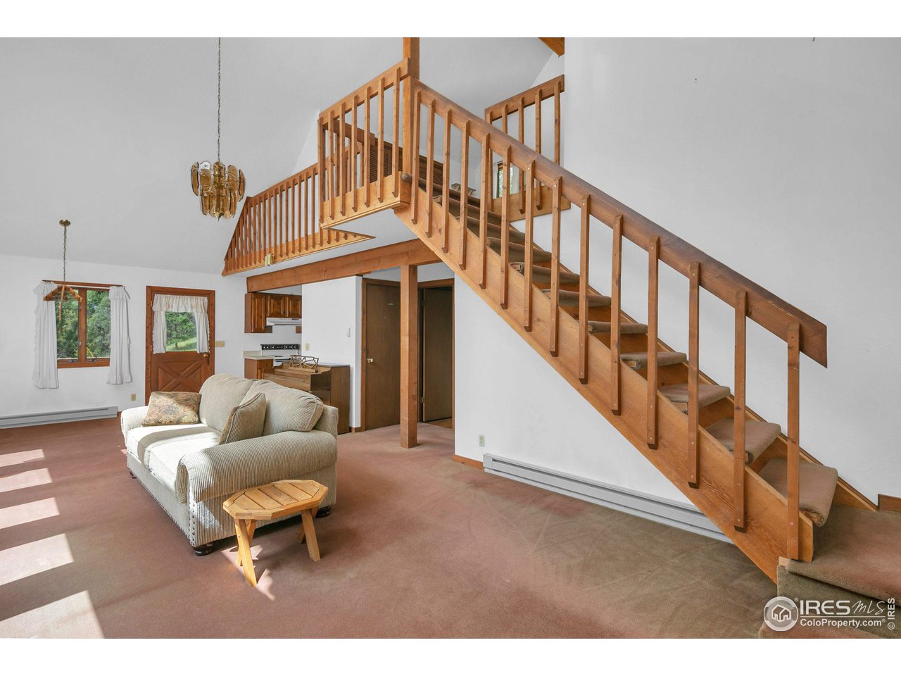 1052 Streamside Drive Drake, CO 80515 - Photo 16 of 31 a living room with furniture and a wooden floor